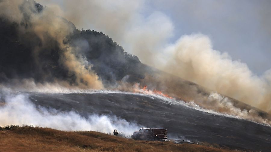 The San Antonio Fire spreads uphill west of Petaluma, California, on Friday. California experienced...