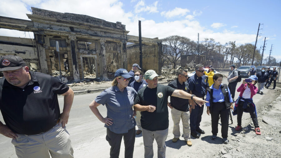 Governor of Hawaii Josh Green, center, points to damage as he speaks with FEMA Administrator Deanne...