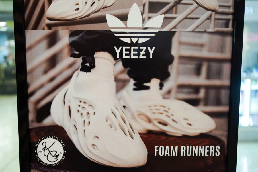FILE - A sign advertises Yeezy shoes made by Adidas at Kickclusive, a sneaker resale store, in Para...