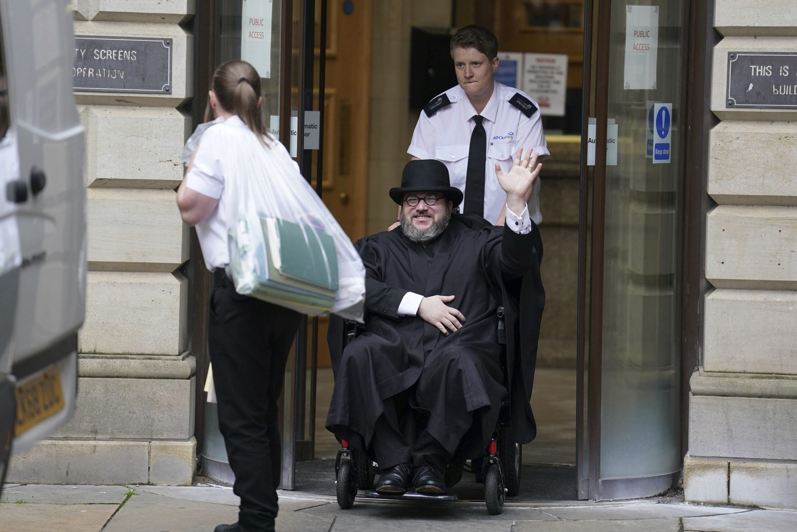 Nicholas Rossi from he U.S. waves as he leaves the Edinburgh Sheriff and Justice of the Peace Court...