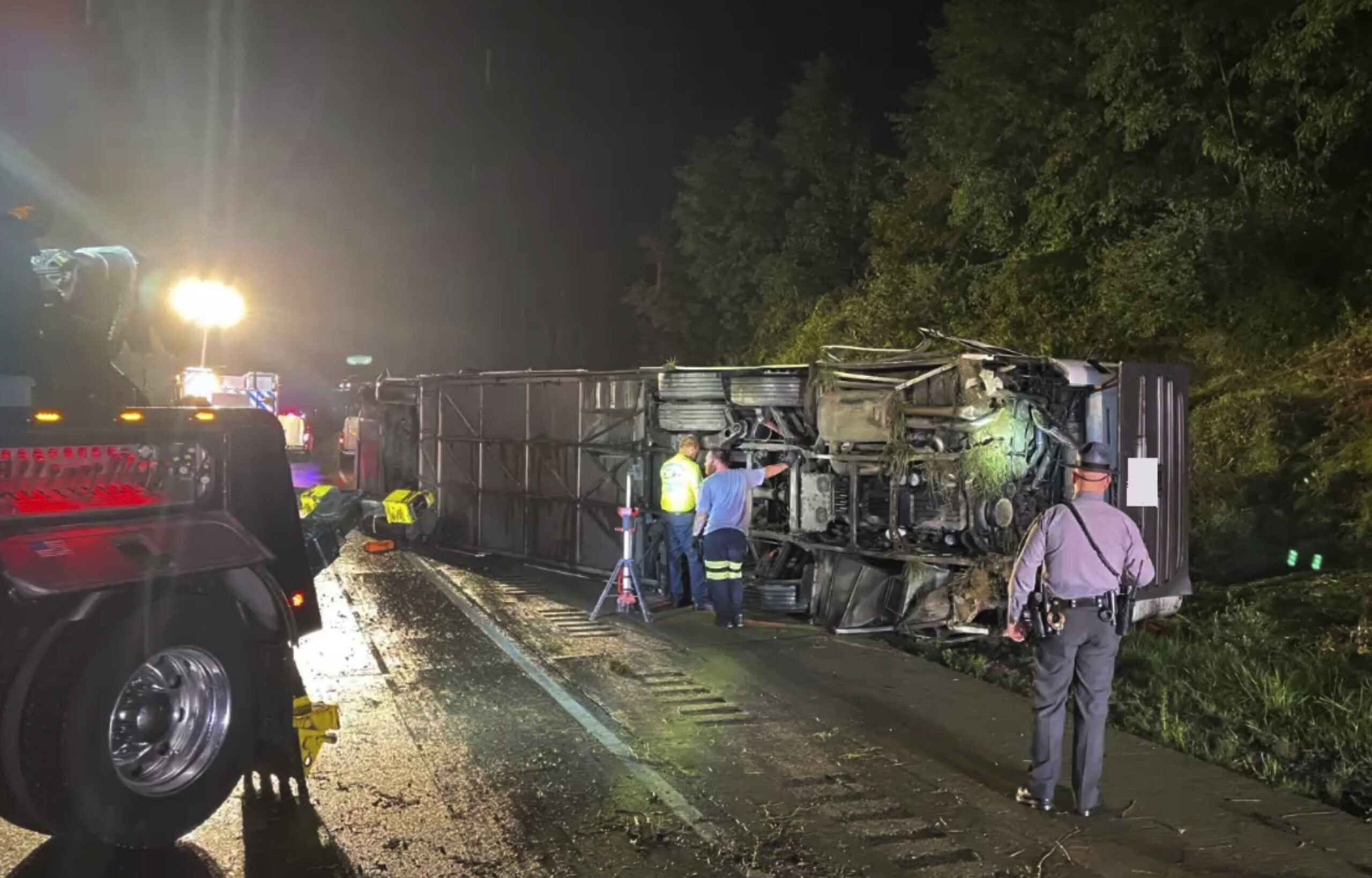 Police and rescue workers arrive on the scene of a bus crash late Sunday, Aug. 6, 2023, in Lower Pa...