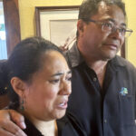 CORRECTS SPELLING OF LAST NAME TO SAMISONI INSTEAD OF SAMISANI - Taufa Samisoni, right, and his wife Katalina speak after attending Mass at Sacred Hearts Mission Church in Kapalua, Hawaii on Sunday, Aug. 13, 2023. Taufa Samisoni's uncle, aunt, cousin and cousin's 7-year-old son died in a wildlife that burned most of the Maui town of Lahaina. (AP Photo/Audrey McAvoy)Credit: ASSOCIATED PRESS