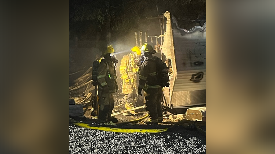 Firefighters in front of one of the destroyed camping trailers. (North Tooele Fire District)...