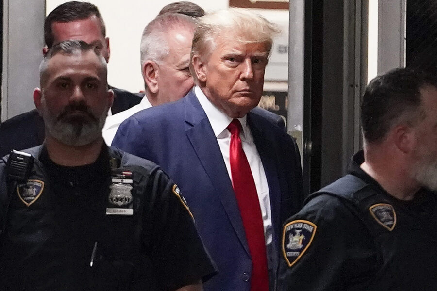 FILE - Former President Donald Trump is escorted to a courtroom, April 4, 2023, in New York. (AP Ph...