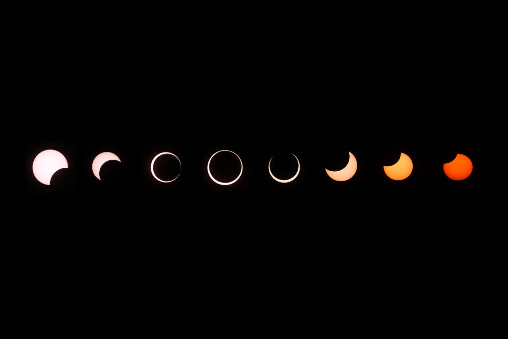 A composite of images of the first annular eclipse seen in the U.S. since 1994 shows several stages...