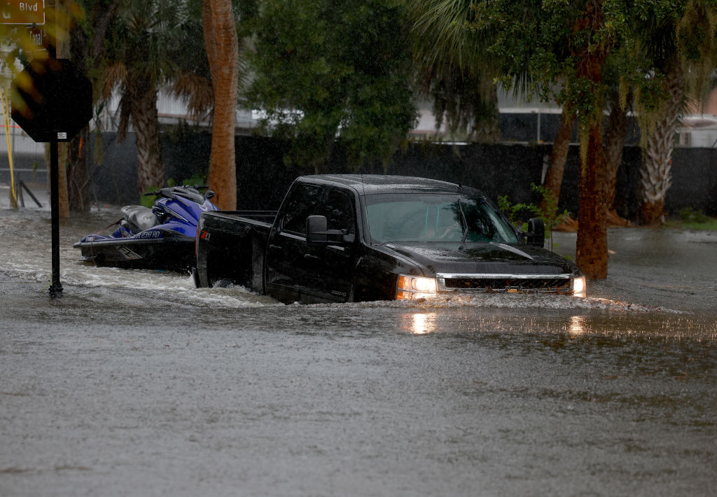 A truck passes through flooded streets caused by Hurricane Idalia passing offshore on August 30, 20...