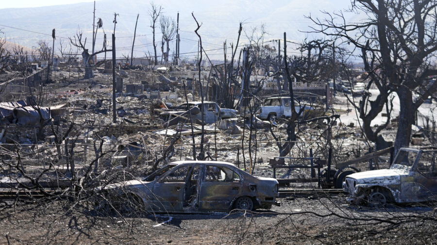 Destroyed homes and cars are shown, Sunday, Aug. 13, 2023, in Lahaina, Hawaii. Hawaii officials urg...