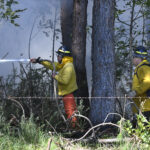 Members of a Hawaii Department of Land and Natural Resources wildland firefighting crew on Maui battle a fire in Kula, Hawaii, on Tuesday, Aug. 8, 2023. Several Hawaii communities were forced to evacuate from wildfires that destroyed at least two homes as of Tuesday as a dry season mixed with strong wind gusts made for dangerous fire conditions. (Matthew Thayer/The Maui News via AP)Credit: ASSOCIATED PRESS