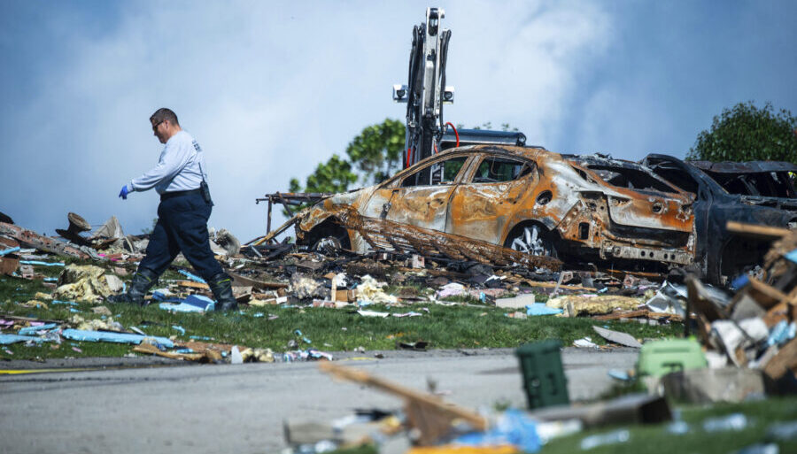 FILE - An investigator walks through the debris from a home explosion on Aug. 13, 2023, which occur...