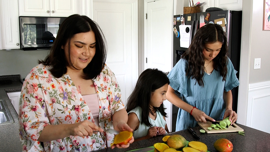 Jessica Leon prepares a meal with her daughters...