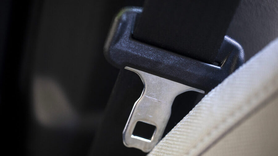 FILE — A seat belt for the right front passenger seat is shown in a vehicle on Monday, Aug. 21, ...
