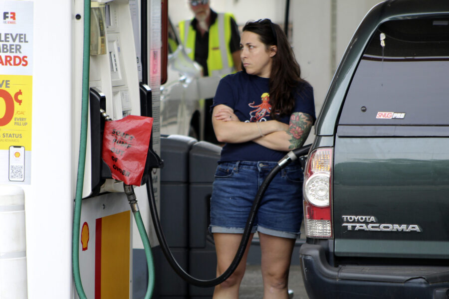 A customer fills up their car with gas at a gas station, Friday, Aug. 4, 2023, in Portland, Ore. Or...
