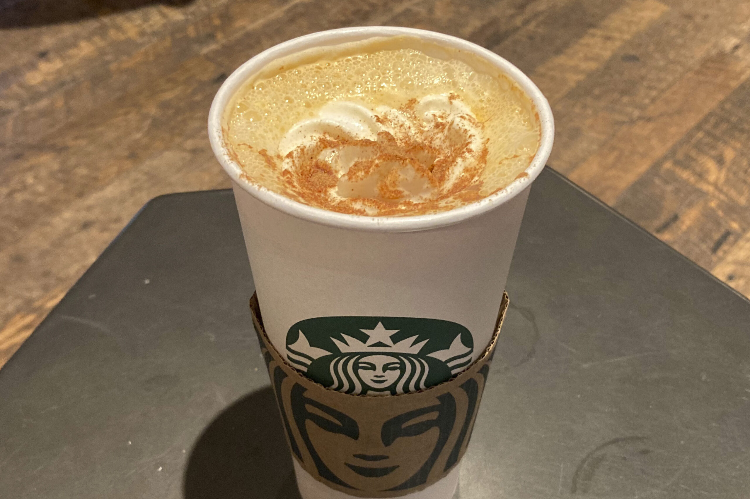 A Pumpkin Spice Latte drink rests on a table at a Starbucks in New York on Thursday, Aug. 24, 2023....