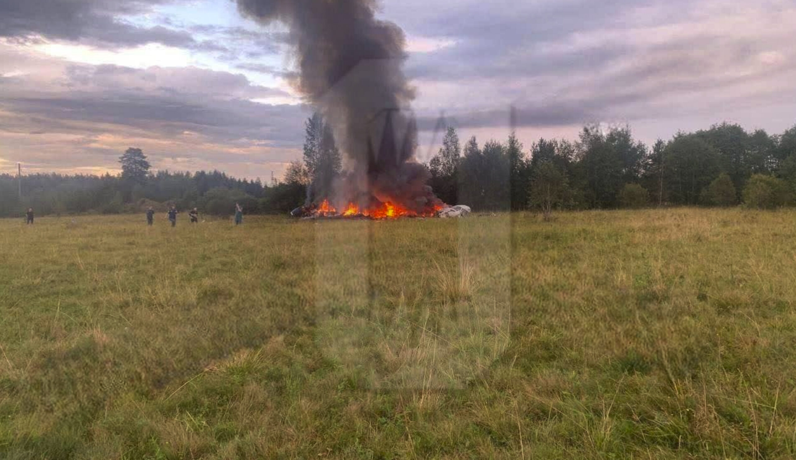 This image released by Ostorozhno Novosti on Wednesday, Aug. 23, 2023, shows the crash site of a pr...