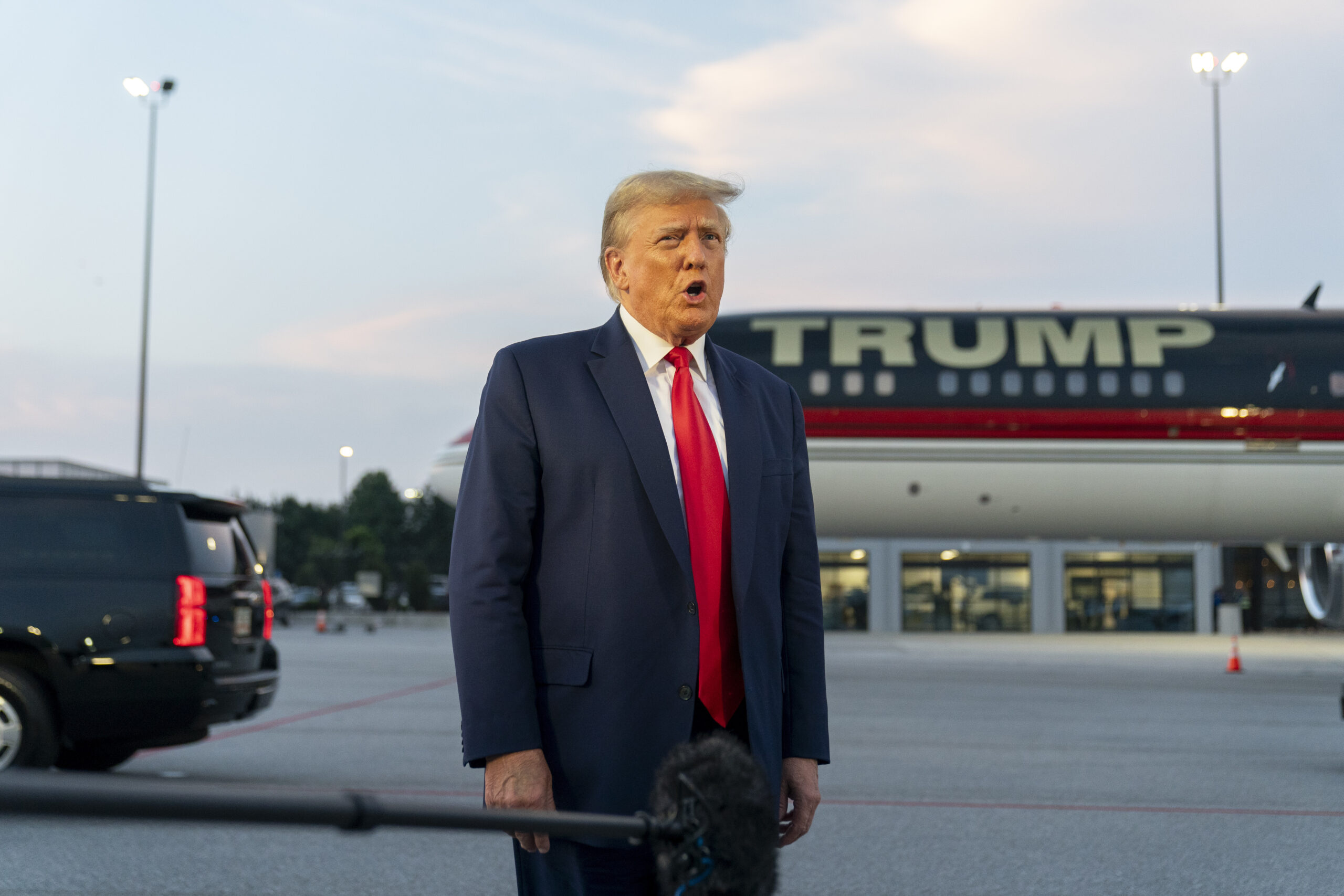 FILE - Former President Donald Trump speaks with reporters before departure from Hartsfield-Jackson...