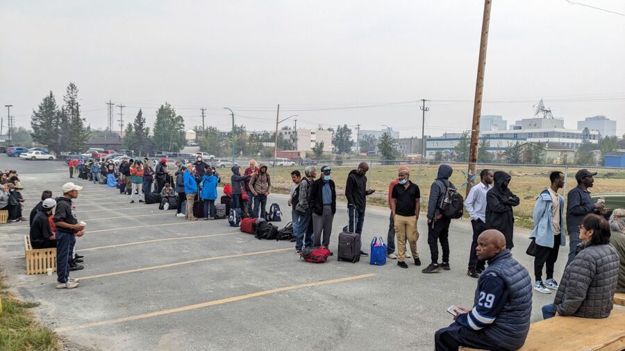 People line up in Yellowknife to register for an evacuation flight on August 17.
Mandatory Credit:	...