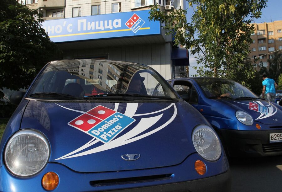Delivery vehicles stand outside a Domino's Pizza store in Moscow, Russia, in 2011.
Mandatory Credit...
