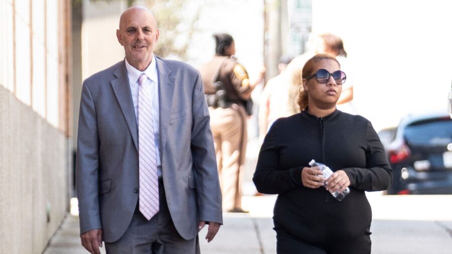 Deja Taylor arrives with attorney James Ellenson at the Newport News Sheriff's Office in April.
Man...