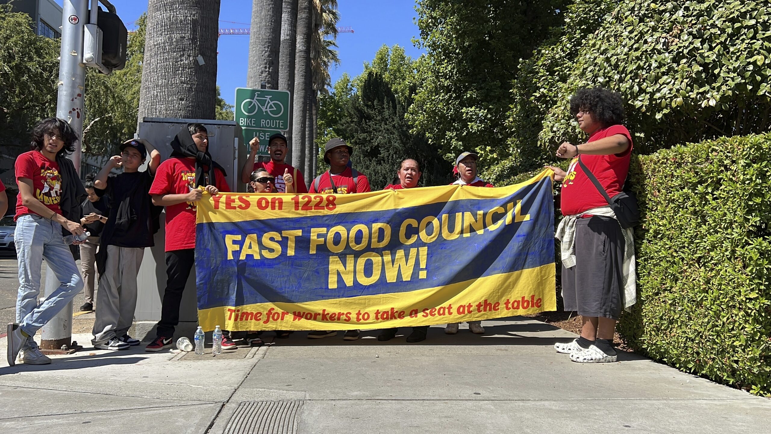 FILE -- Fast food workers and union activists demonstrate outside the California State Capitol to r...