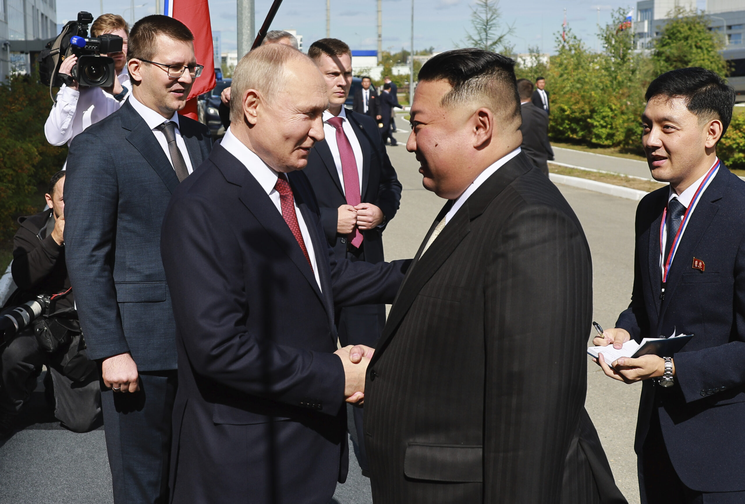 Russian President Vladimir Putin, left, and North Korea's leader Kim Jong Un shake hands during the...