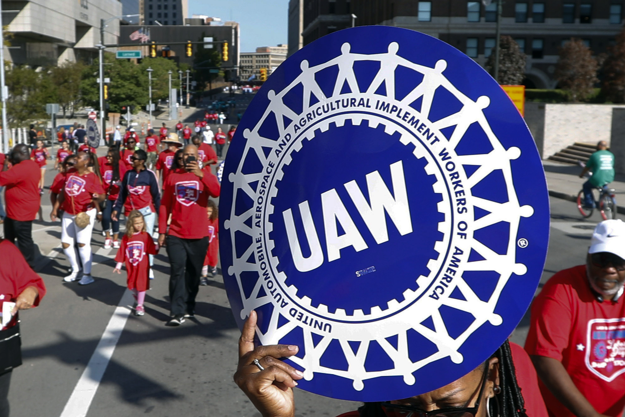 FILE - United Auto Workers members walk in the Labor Day parade in Detroit, Sept. 2, 2019. Automake...