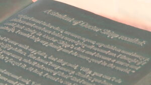 The text imbedded on the book that Dr. Ellis Reynolds Shipp is holding.