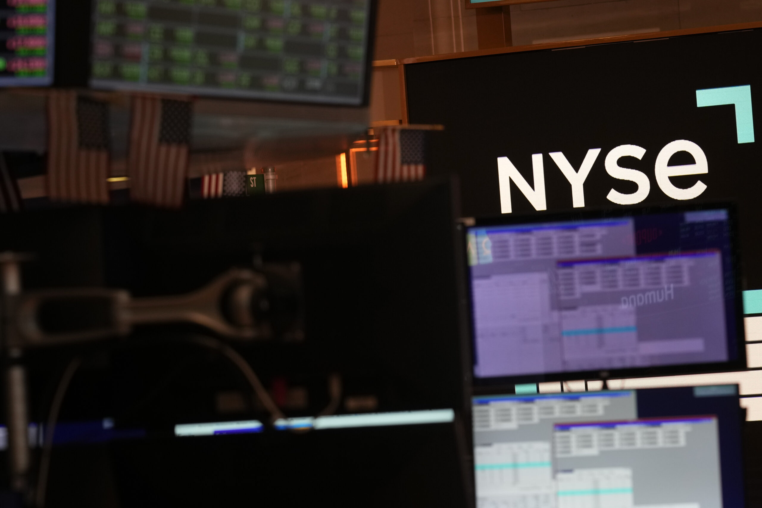 FILE - A screen displays the NYSE logo on the floor at the New York Stock Exchange in New York, Fri...