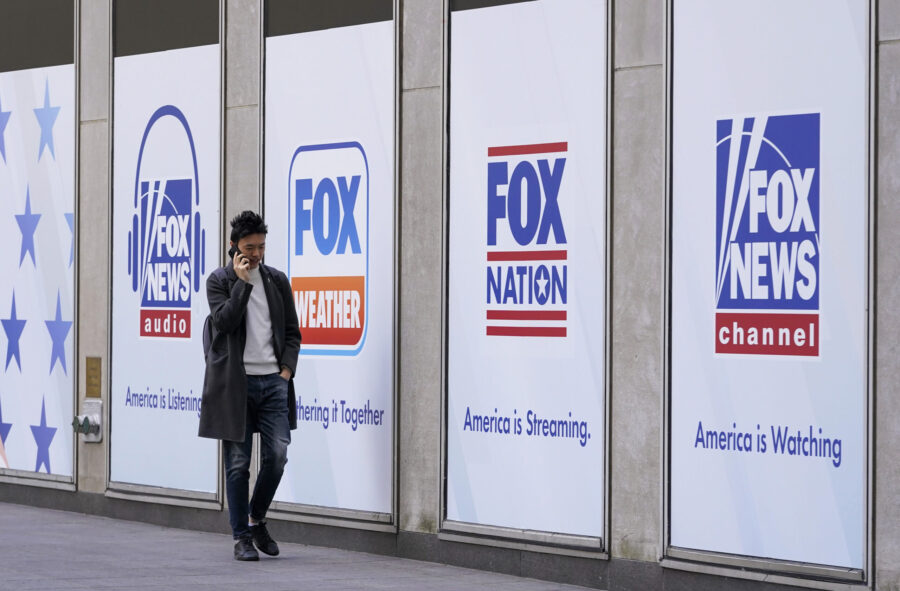 FILE - A person walks past the News Corp. and Fox News headquarters on April 19, 2023, in New York....