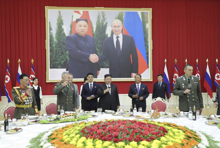 In this photo provided by the North Korean government, North Korean leader Kim Jong Un, center, and...