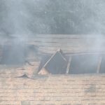 The damaged roof as smoke exited it. (KSL TV)