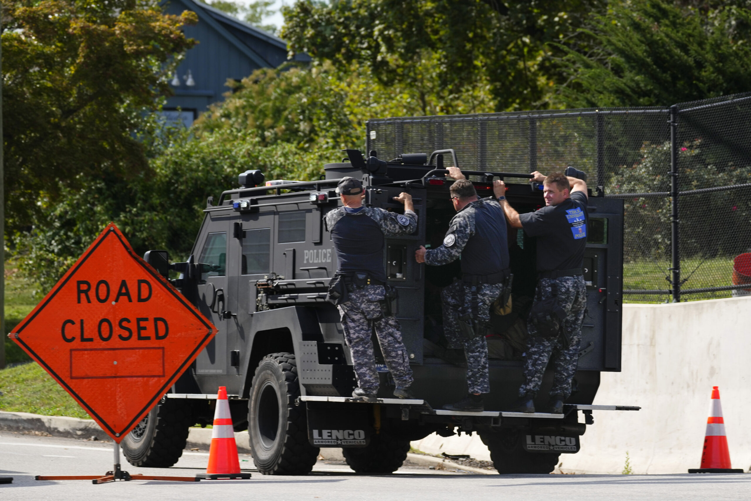 Law enforcement officers ride by a roadblock as the search for escaped convict Danelo Cavalcante co...