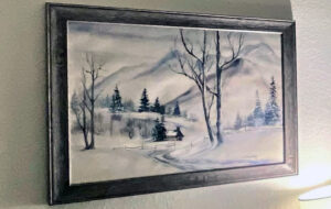 snow landscape painting hanging on a wall