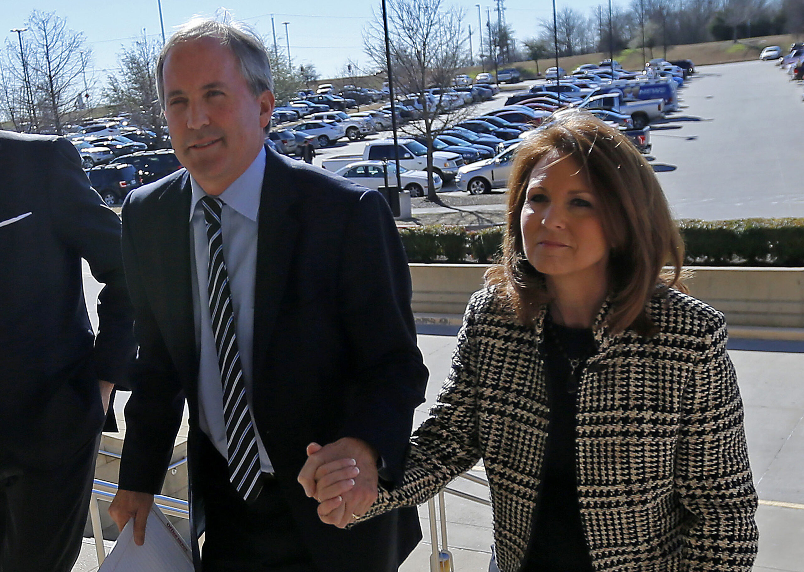 FILE - Texas Attorney General Ken Paxton, left, arrives at the Collin County Courthouse with his wi...