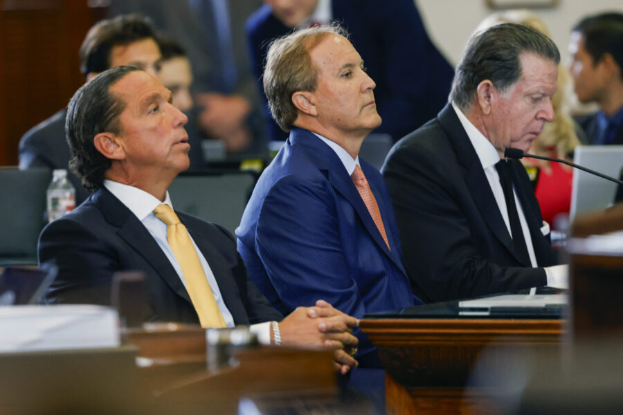 Texas state Attorney General Ken Paxton, center, sits with his attorneys Dan Cogdell, right, and To...