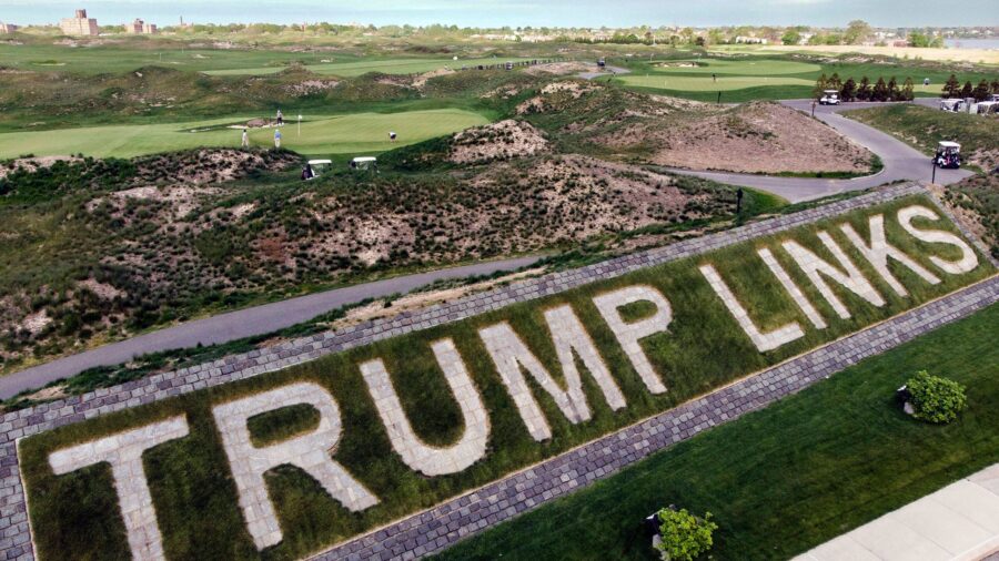 In this May 2021 photo, patrons play the links as a giant branding sign is displayed with flagstone...