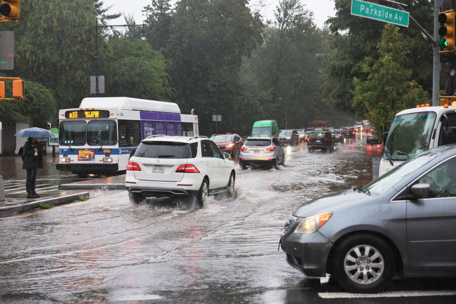 Cars drive through slight flooding on Ocean Avenue amid heavy rain on September 29 in the Flatbush ...