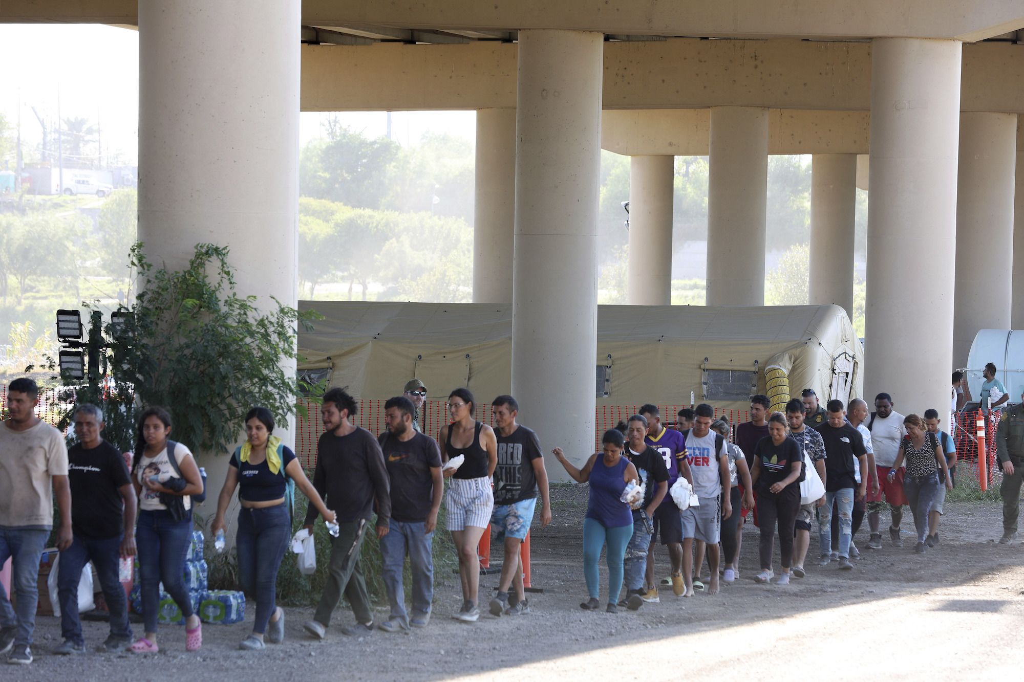 Border Patrol agents process hundreds of migrants September 20 under the International Bridge II in...
