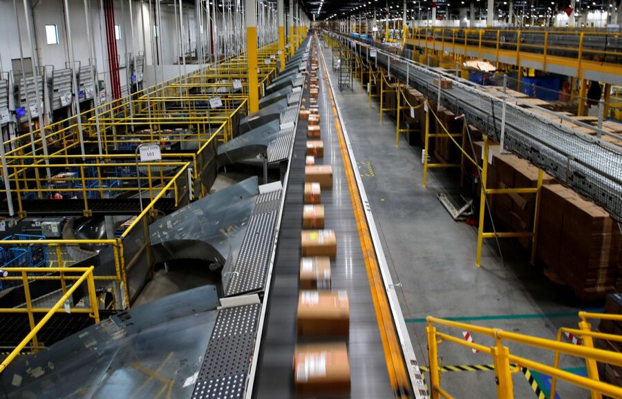 A fast-moving conveyor moves packages to delivery trucks during operations on Cyber Monday at Amazo...