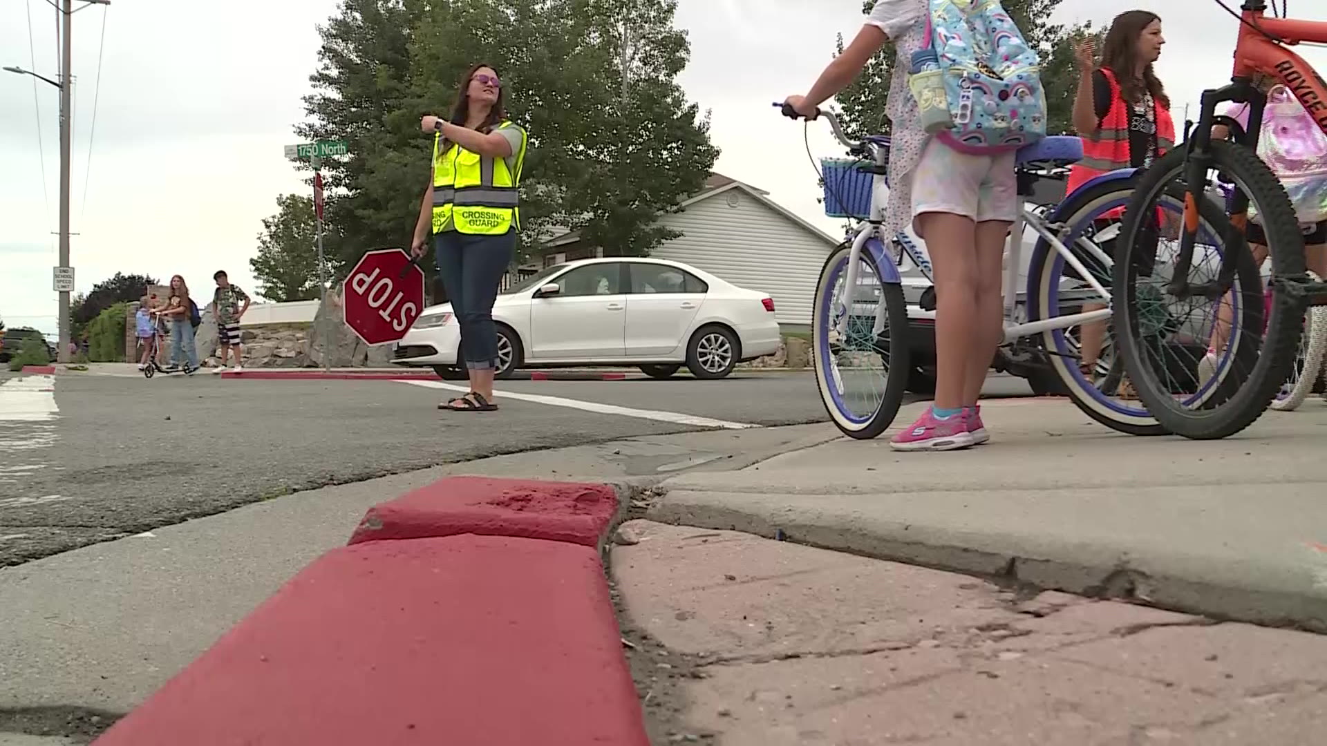 A crossing guard helping a student cross the street. (KSL TV)...