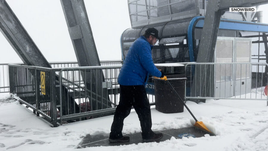 A staff worker at Snowbird shoveling snow at the top of the tram. (KSL TV)...