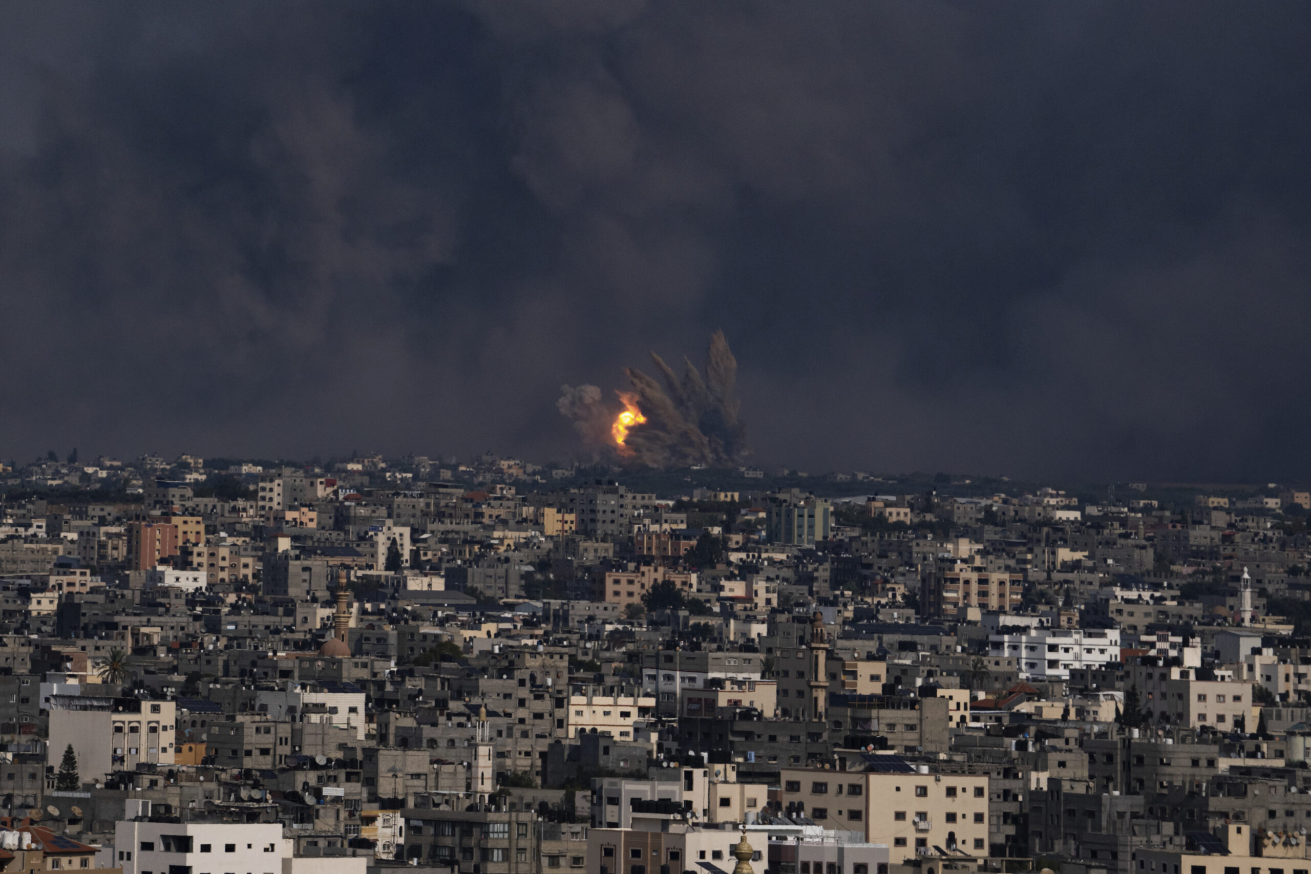 Fire and smoke rise following an Israeli airstrike, in Gaza City, Sunday, Oct. 8, 2023. The militan...
