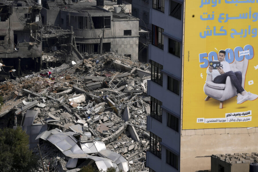 A Palestinian inspects the rubble of a high rise building destroyed by Israeli airstrikes in Gaza C...