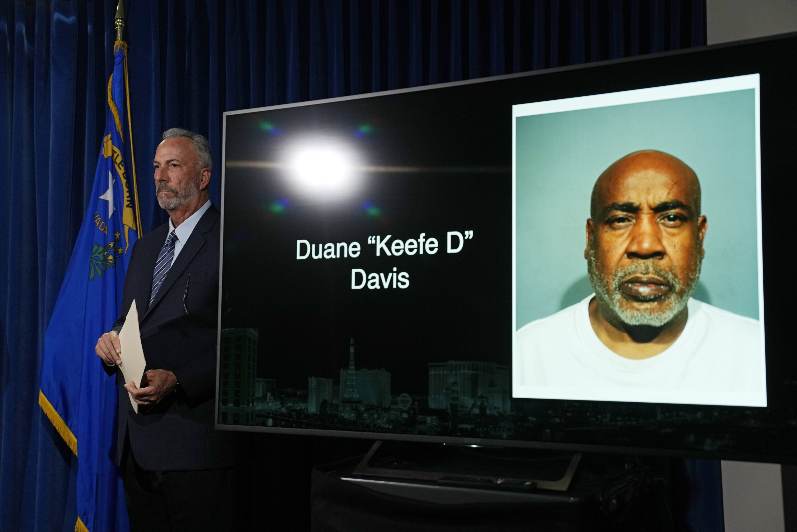 Clark County District Attorney Steve Wolfson stands beside a photo of Duane "Keffe D" Davis during ...