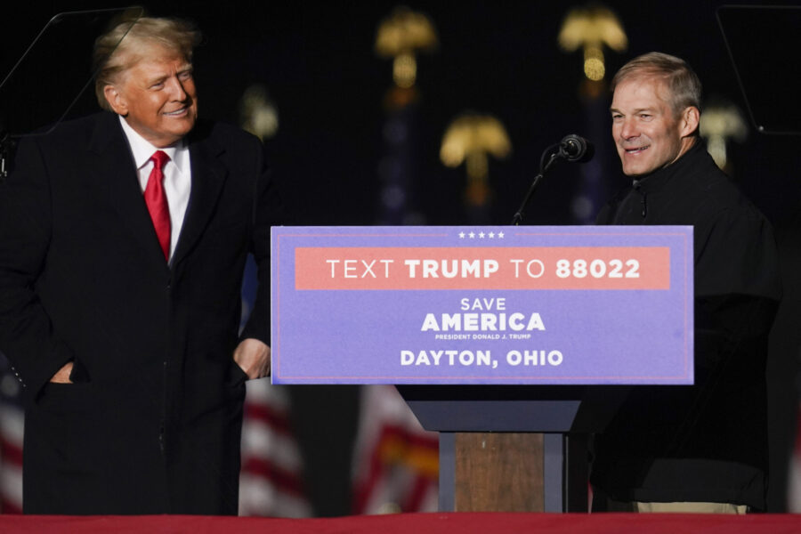 Former President Donald Trump welcomes Rep. Jim Jordan, R-Ohio, to the stage at a campaign rally in...