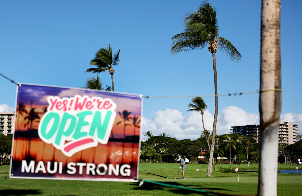 A person golfs on the first day of tourism resuming in west Maui, two months after a devastating wi...