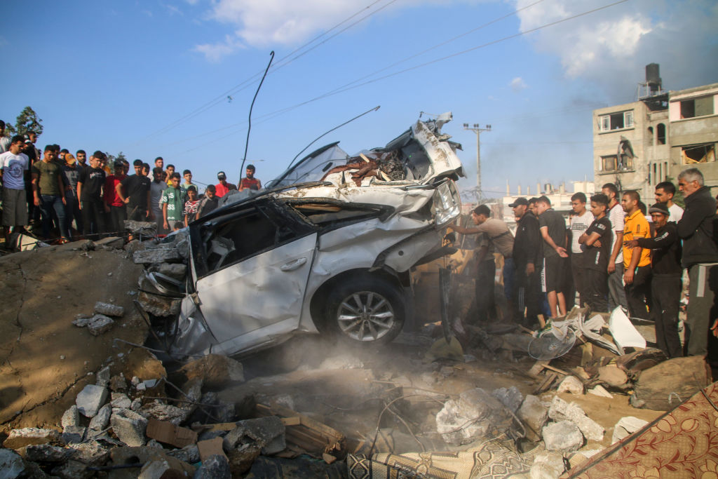 Palestinian citizens inspect their home destroyed during Israeli raids in the southern Gaza Strip o...
