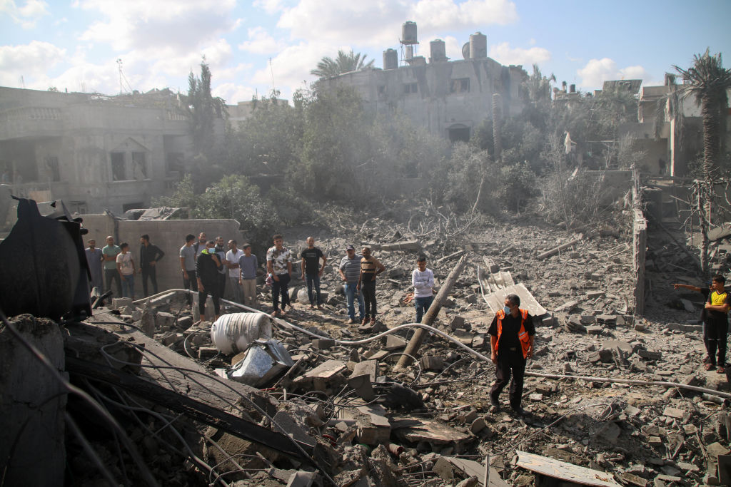 Palestinian emergency services and local citizens search for victims in buildings destroyed during ...