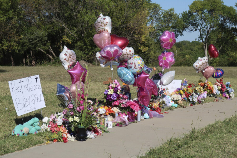 Zoey Felix, a 5-year-old girl, is honored with a makeshift memorial of flowers, balloons, signs and...