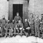 A postcard sent from Record's great-grandfather John Dorius to his daughter in 1888. Dorius was imprisoned in the old Utah Penitentiary in Sugar House for polygamy, along with other famous LDS leaders. Dorius is the third from the right in the prison photo. (Courtesy: Joan Record via Deseret News)