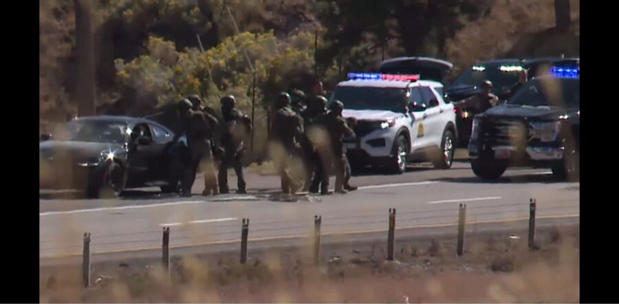 A barricade of officers approaching a high-risk traffic stop vehicle on I-15 in Cedar City. (Marc W...